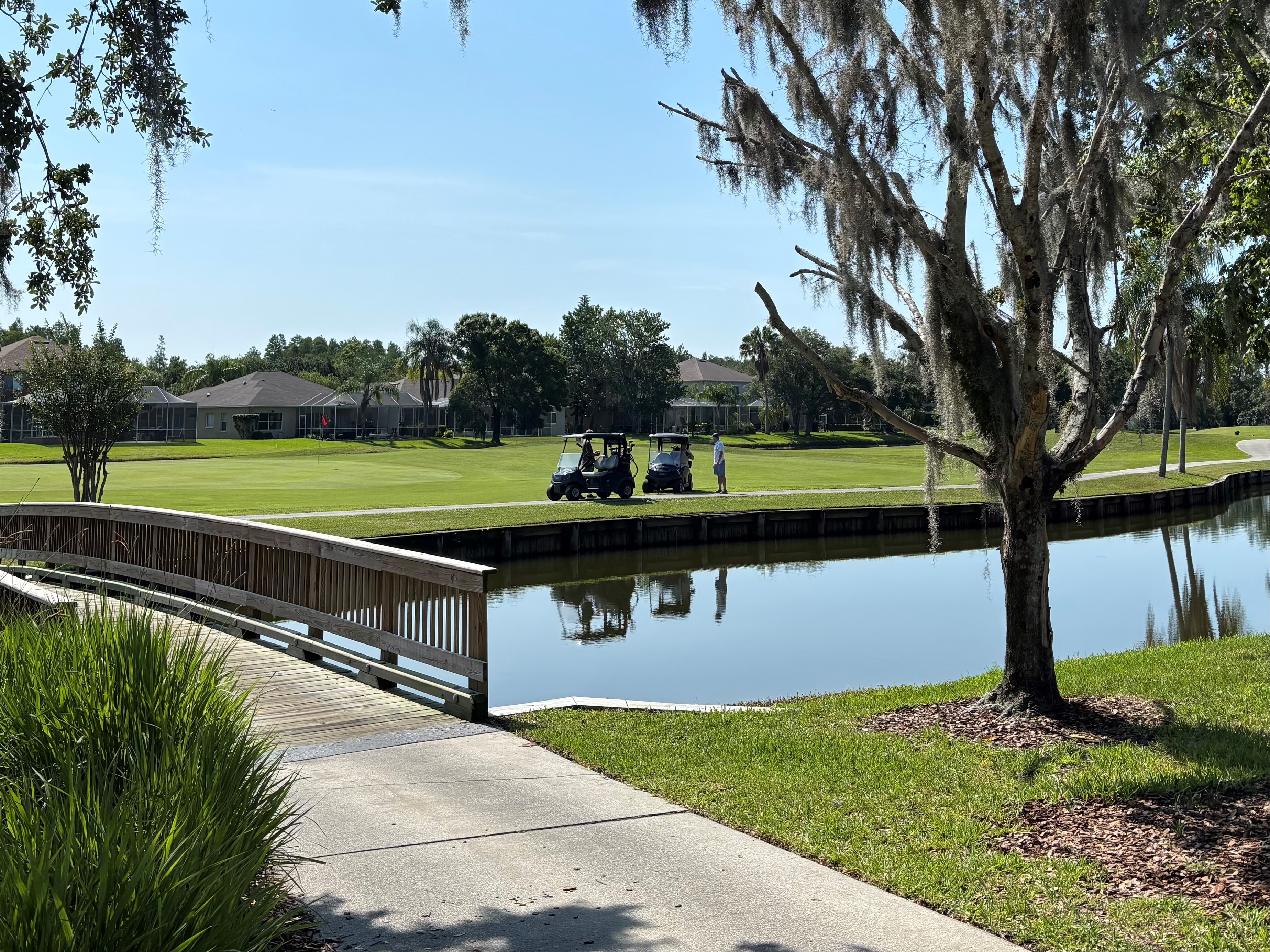 Golf carts on golf course near path
